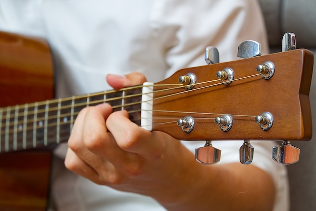 Ragazzo giovane a suonare la chitarra.