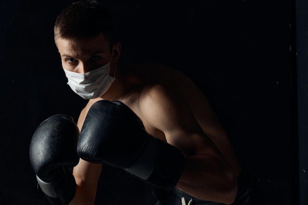 Ragazzo in maschera medica e guanti da boxe su sfondo isolato vista ritagliata Copy Space