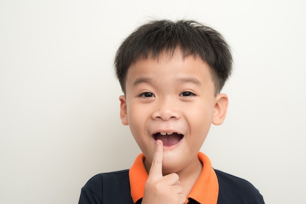 Ragazzo sorridente sdentato che mostra il suo latte dei denti persi