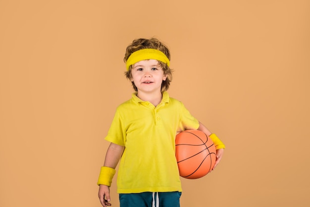 Ragazzo sportivo con sport con la palla bambino attivo tiene ragazzo di basket in abbigliamento sportivo fitness sano