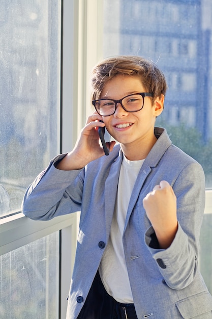 Ragazzo teenager che per mezzo del telefono cellulare