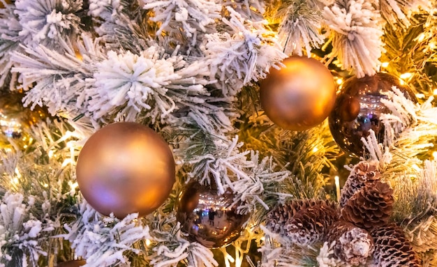 Ramo di abete con palline e luci festive sullo sfondo di Natale con scintillii.