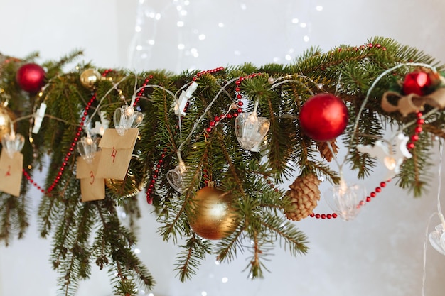 ramo di albero di Natale decorato con calendario dell'avvento appeso realizzato con le tue mani