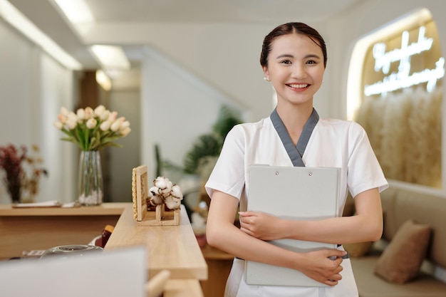 Receptionist sorridente del salone della stazione termale