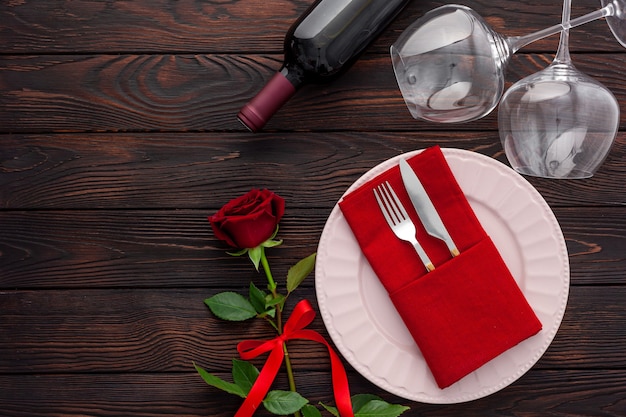 Regolazione della tavola di San Valentino con piatto, vino e bicchieri