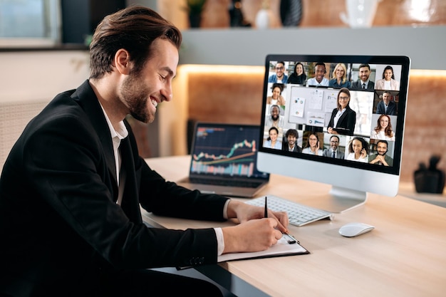 Remote business briefing brainstorming Positive caucasian male manager ceo participates in a video conference with group of multiracial colleagues discussing the financial strategy of new project