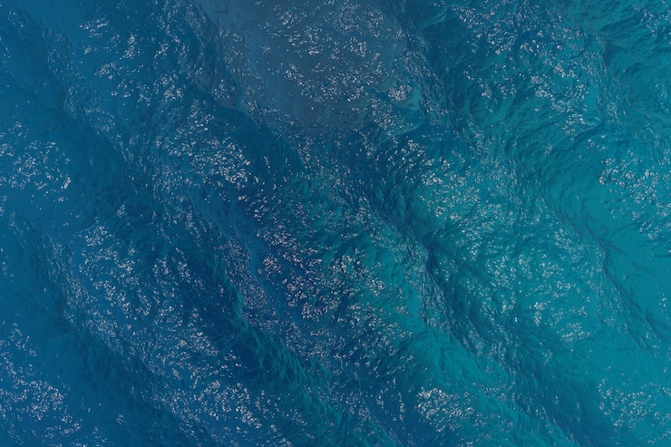 Render 3D realistis laut biru tua pemandangan atas ombak air tenang dan damai serta tekstur latar belakang teluk musim panas yang indah. Render 3D.