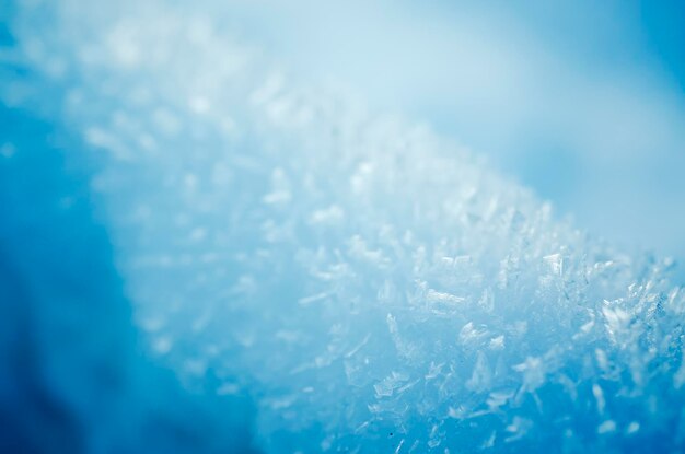 Reticolo blu ghiacciato di inverno con i fiocchi di neve d'annata retro priorità bassa stagionale di festa