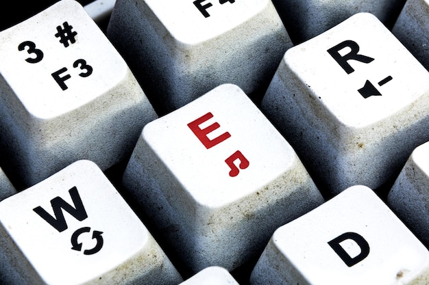 retro keyboard with e button in red color e button keyboard in close up macro
