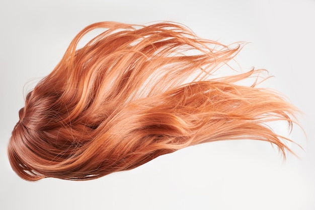 Riccioli rossi dai capelli lucidi e naturali isolati su sfondo bianco con spazio per la copia