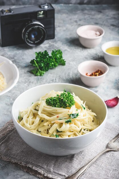 Ricetta pranzo facile. Linguine all'olio d'oliva, aglio, prezzemolo fresco e parmigiano grattugiato.