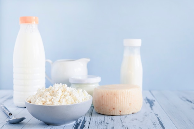 Ricotta fresca e bottiglie di mik su sfondo blu