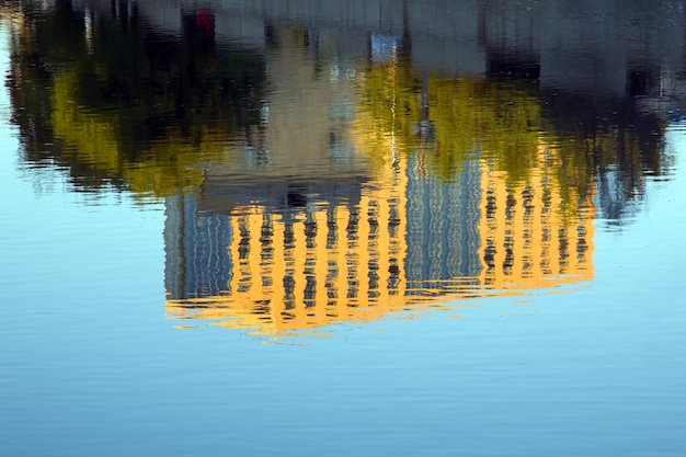 Riflessione della casa nell'acqua contro il cielo