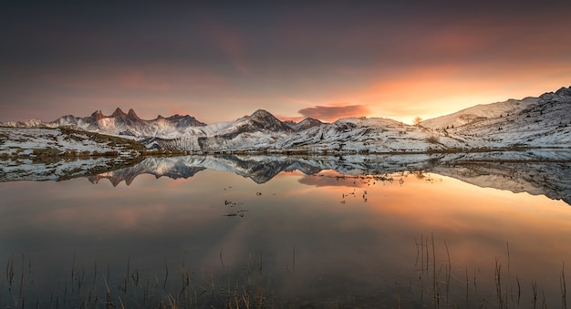 Riflessione delle montagne al tramonto nelle Alpi