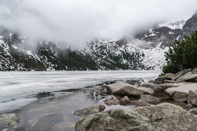 Riflessione delle montagne nei monti Tatra Morskie oko lago di primavera.