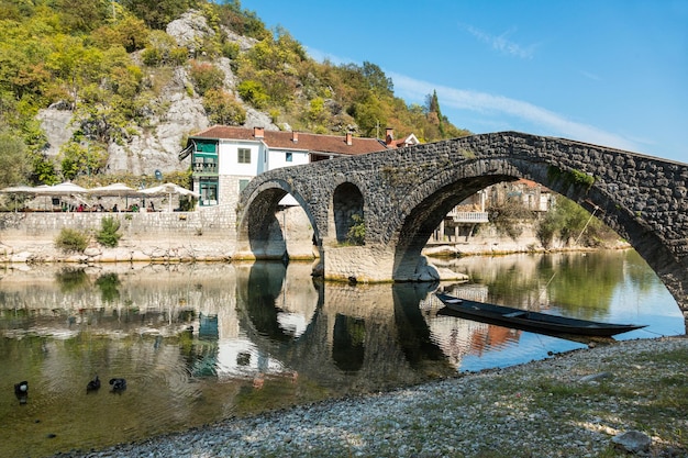 Rijeka Crnojevica Montenegro 26 settembre 2016 Il vecchio ponte ad arco in pietra e una banca di Rijeka Crnojevica Montenegro