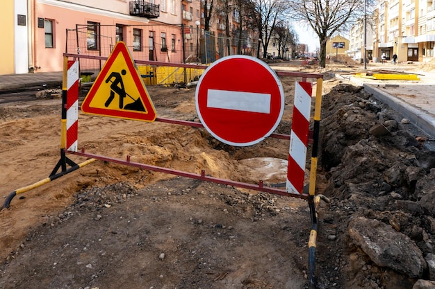 Riparazione di marciapiedi e strade della città Un tratto di strada chiuso al traffico Un segnale stradale che indica una zona pericolosa e che vieta la circolazione