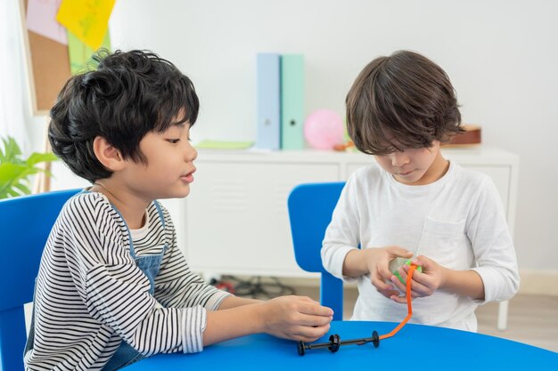 Ritorno a scuola e corso estivo. I bambini piccoli giocano a palloncini colorati nell'aula dell'asilo.