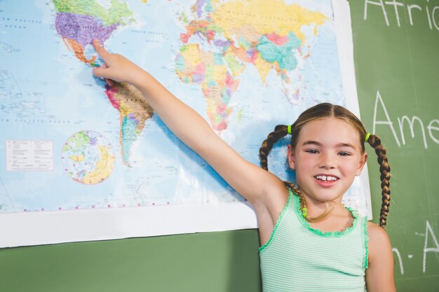 Ritratto della scolara che indica alla mappa in aula