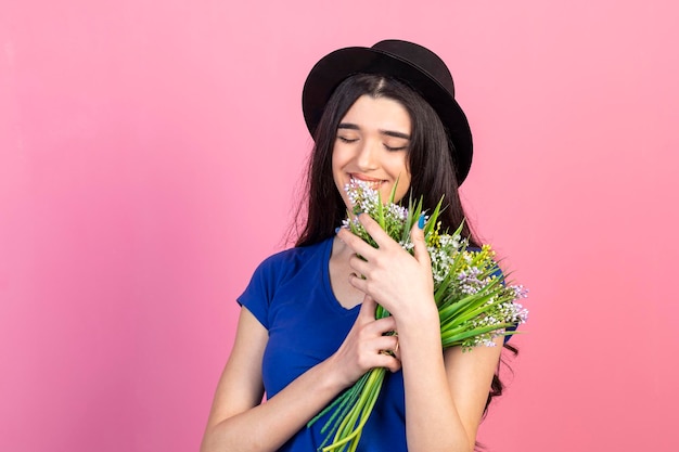 Ritratto di bella signora abbracciò un mazzo di fiori e li guardò