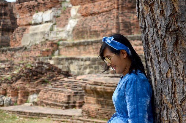 Ritratto di donne tailandesi con albero in un antico edificio al Wat Mahathat ad Ayutthaya Thailandia