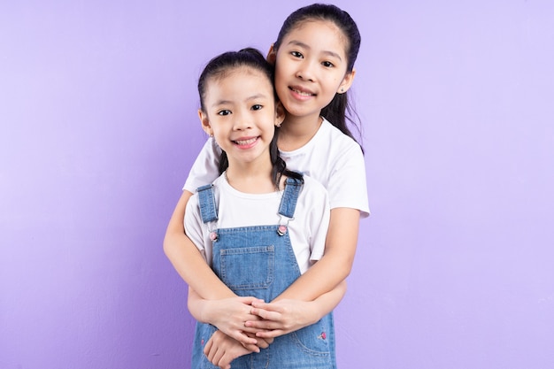 Ritratto di due ragazze asiatiche su sfondo viola