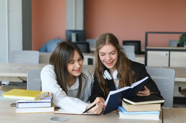 Ritratto di due ragazze sul posto di lavoro con i libri Istruzione scolastica