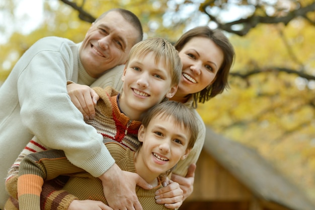 Ritratto di famiglia che si rilassa nel parco autunnale