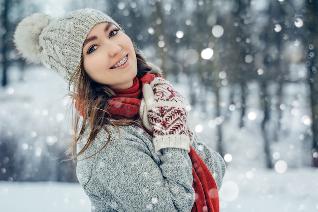 Ritratto di giovane donna inverno. Ragazza di modello allegra di bellezza che ride e che si diverte nel parco di inverno. Bella giovane femmina all'aperto, godersi la natura, orario invernale