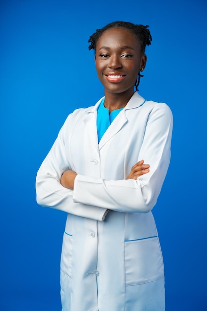 Ritratto di giovane dottoressa africana in studio blu