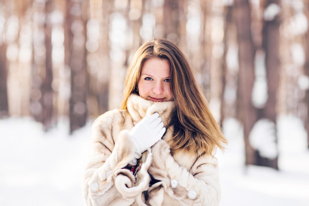Ritratto di inverno di pelliccia da portare della giovane bella donna. Concetto di moda bellezza inverno neve.