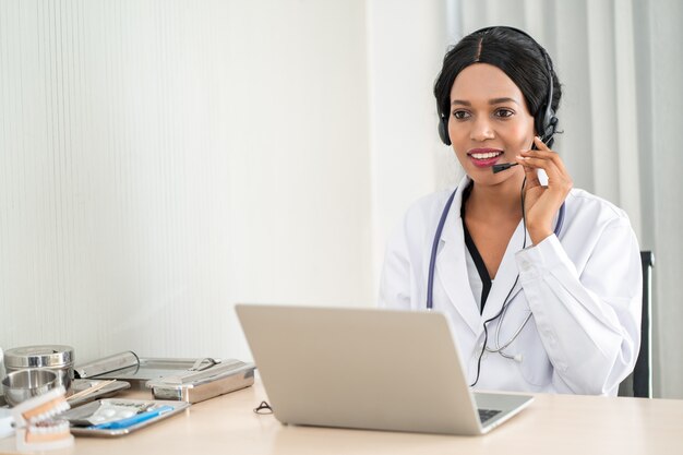 Ritratto di medico in cuffia consulenza paziente per telefono