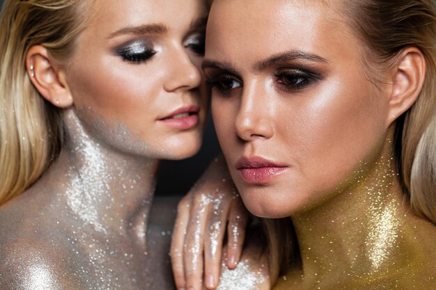 Ritratto di moda di belle donne con il primo piano del viso trucco glitter oro e argento