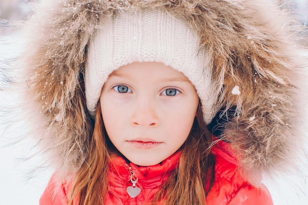 Ritratto di piccola ragazza adorabile nel giorno di inverno soleggiato della neve