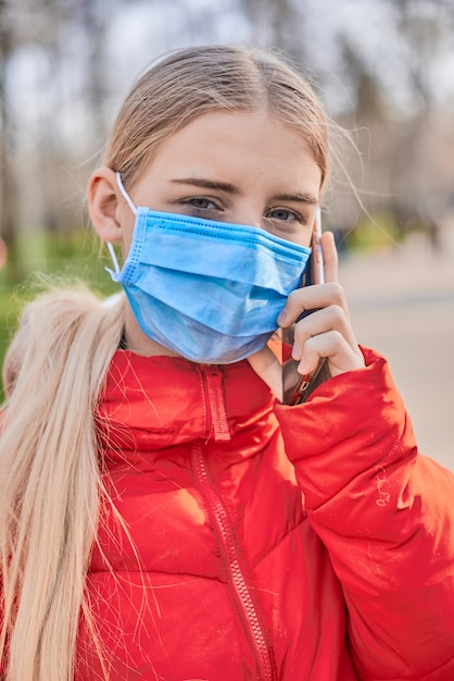 Ritratto di ragazza adolescente in maschera medica per strada