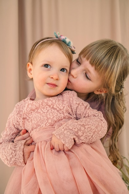 ritratto di sorelle carine ragazze bambini che abbracciano e sorridono