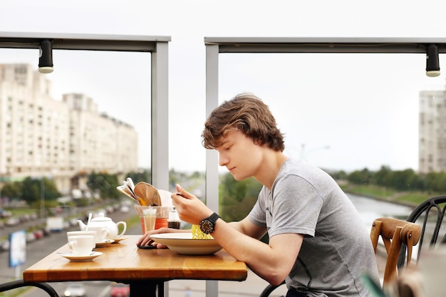 Ritratto di stile di vita di un giovane che usa uno smartphone all'aperto