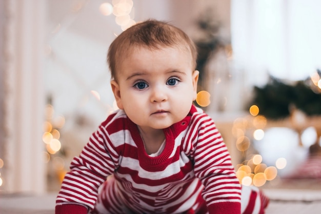 Ritratto di un bambino piccolo che striscia sul letto a Natale