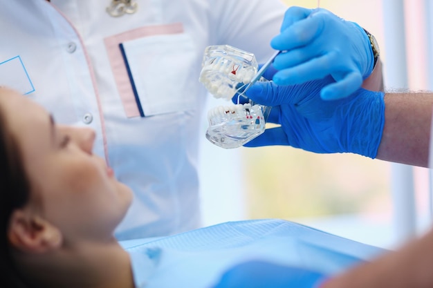 Ritratto di un dentista che tratta i denti del paziente della giovane donna