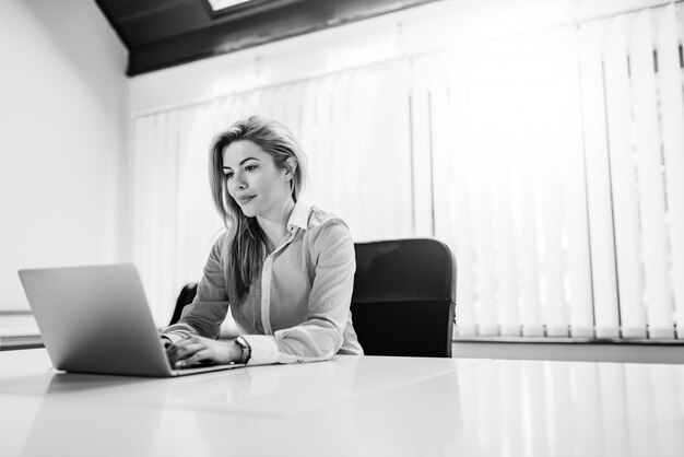 Ritratto di un imprenditore femminile splendida che lavora al computer.