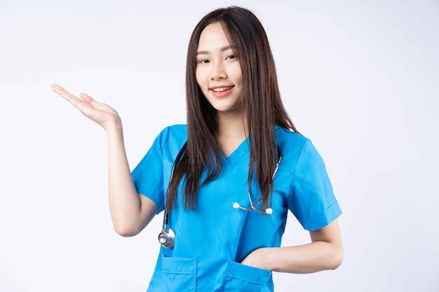 Ritratto di un'infermiera asiatica su un muro bianco