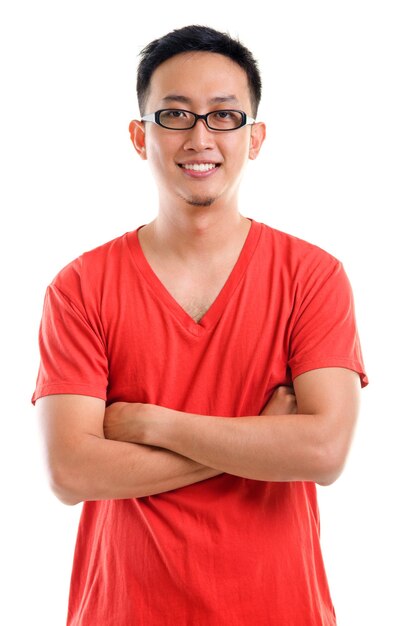 Ritratto di un uomo adulto sorridente con le braccia incrociate in piedi su uno sfondo bianco