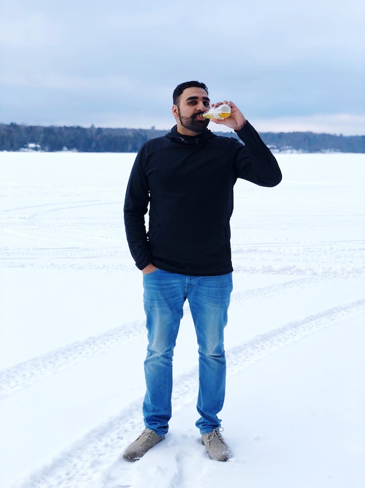 Foto ritratto di un uomo che beve su un campo innevato
