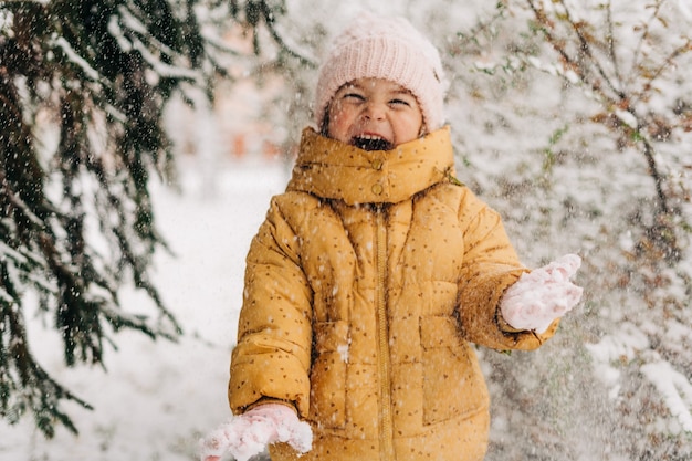 Ritratto di una bambina che gioca con la neve