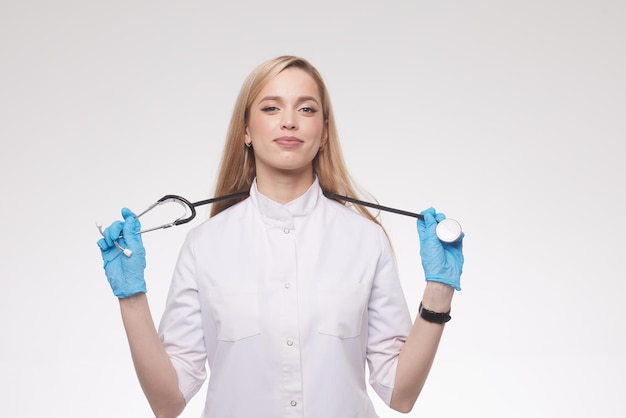 Ritratto di una bella ragazza medico su uno sfondo blu pulito