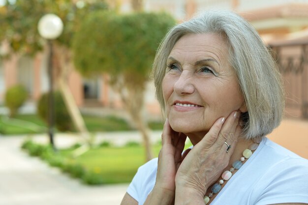 Ritratto di una donna anziana felice al resort tropicale