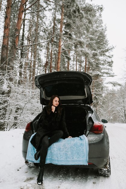 Ritratto di una donna sullo sfondo di un bosco innevato