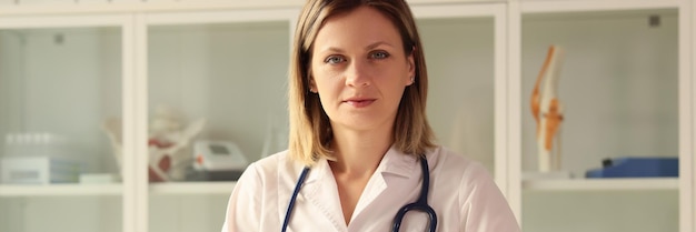 Ritratto di una giovane donna a un tavolo in una clinica una diagnosi di concetto di primo piano della salute