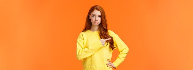 Ritratto di una giovane donna in piedi su uno sfondo giallo