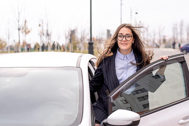 Ritratto di una giovane donna in piedi vicino all'auto